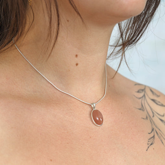 Moonstone, orange pendant (oval) set in silver